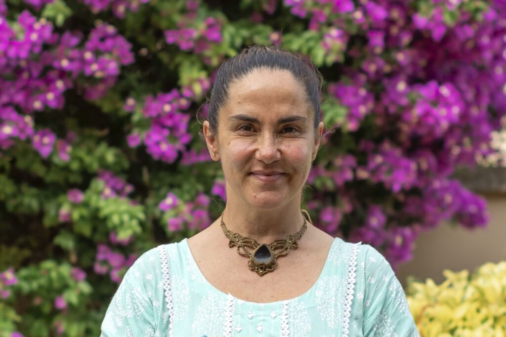 Woman in front of a blooming background.